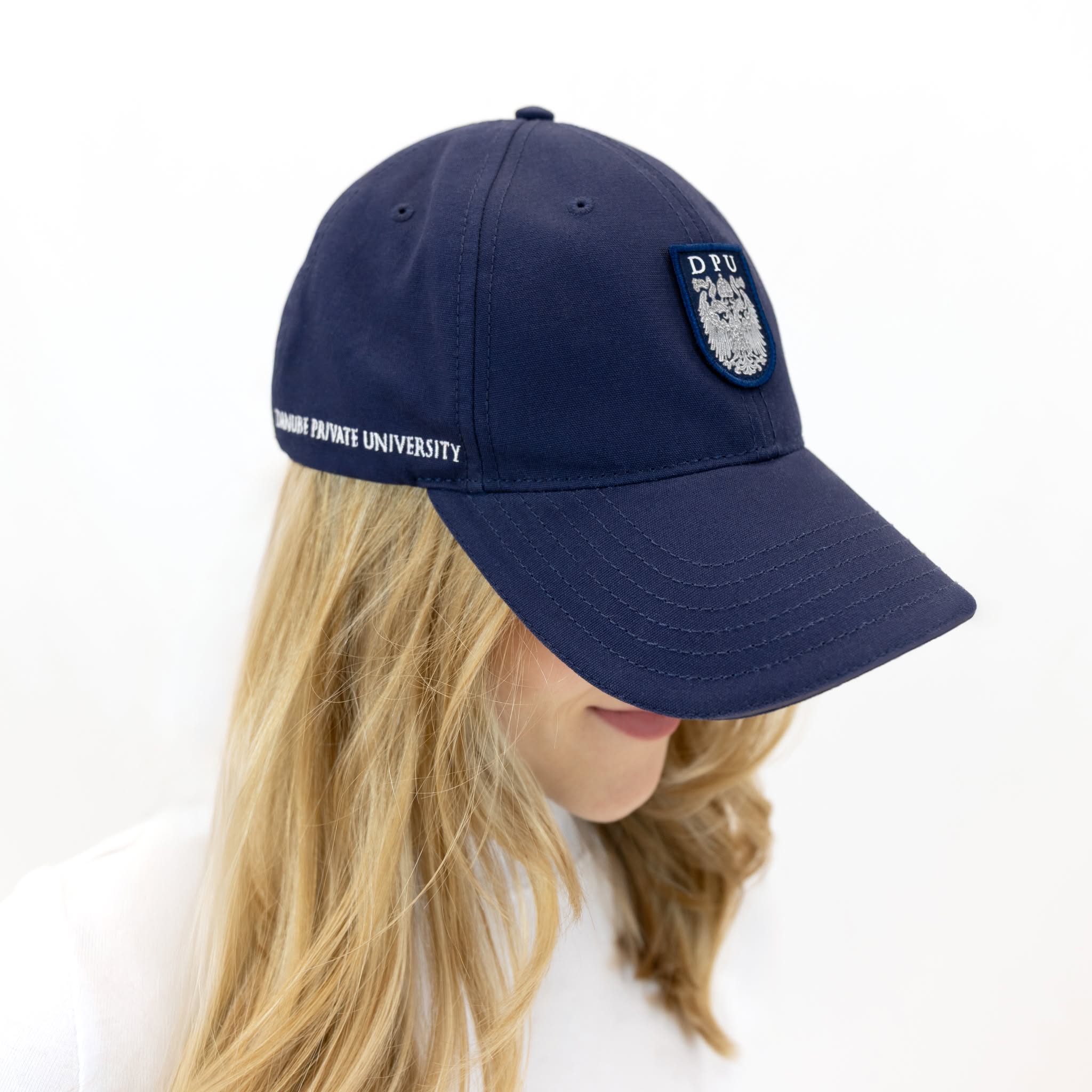 Blaue DPU-Baseballkappe mit tonfarbenem, aufgenähtem Wappen-Patch auf der Vorderseite und gesticktem DPU-Schriftzug an der rechten Kappenseite.